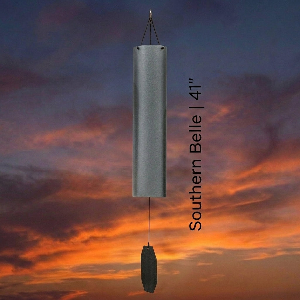 Lambright Country Chimes Southern Belle 41-inch Amish handcrafted wind bell with silver finish and elongated clapper against a sunset sky