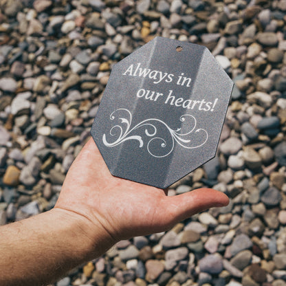 Close-up of a custom engraved wind chime sail with the message 'Always in our hearts!' and decorative scrollwork, perfect for a sympathy or bereavement gift.